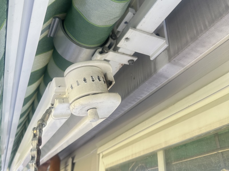 Cheap awning using bicycle chain instead of cables - rusted and failing