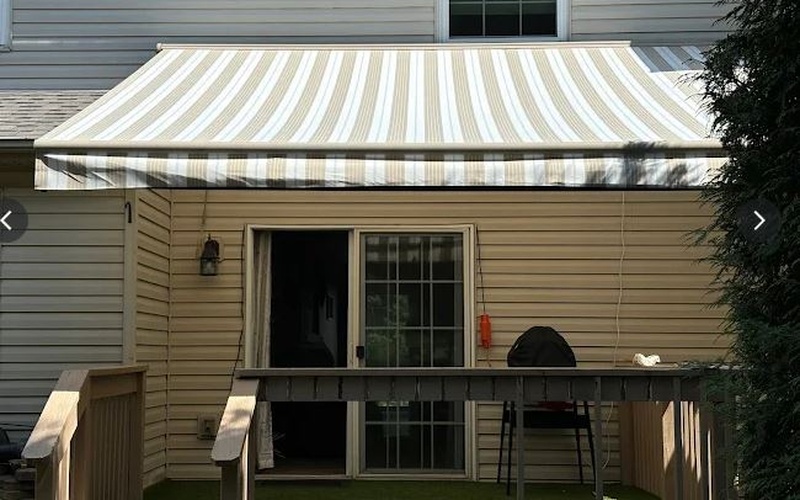 Competitor awning showing wrinkled fabric on a new installation