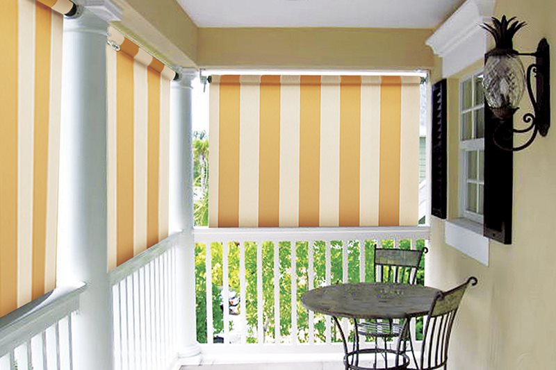 Porch drop shade with striped fabric on covered porch