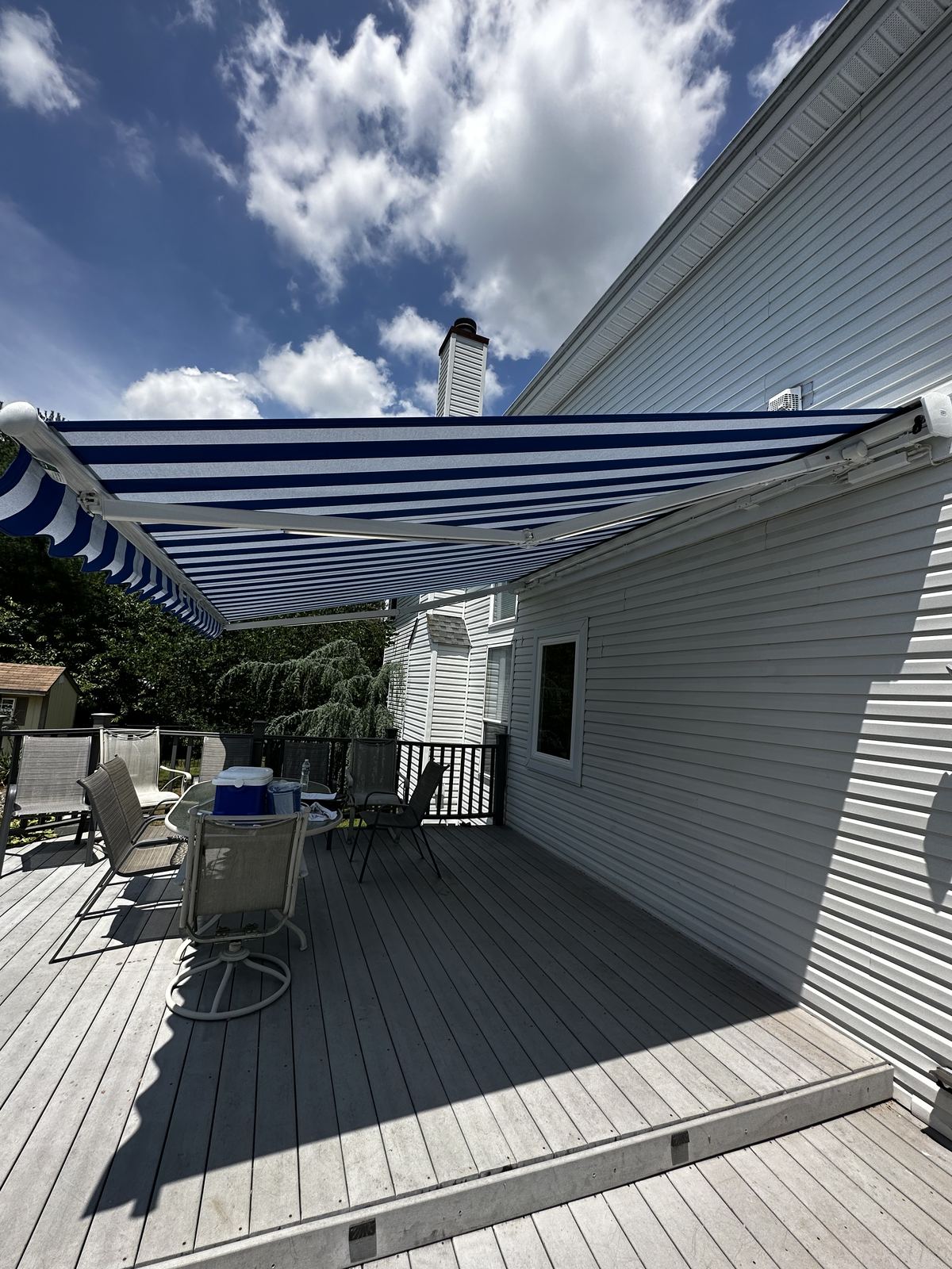 Blue and white striped retractable awning deck