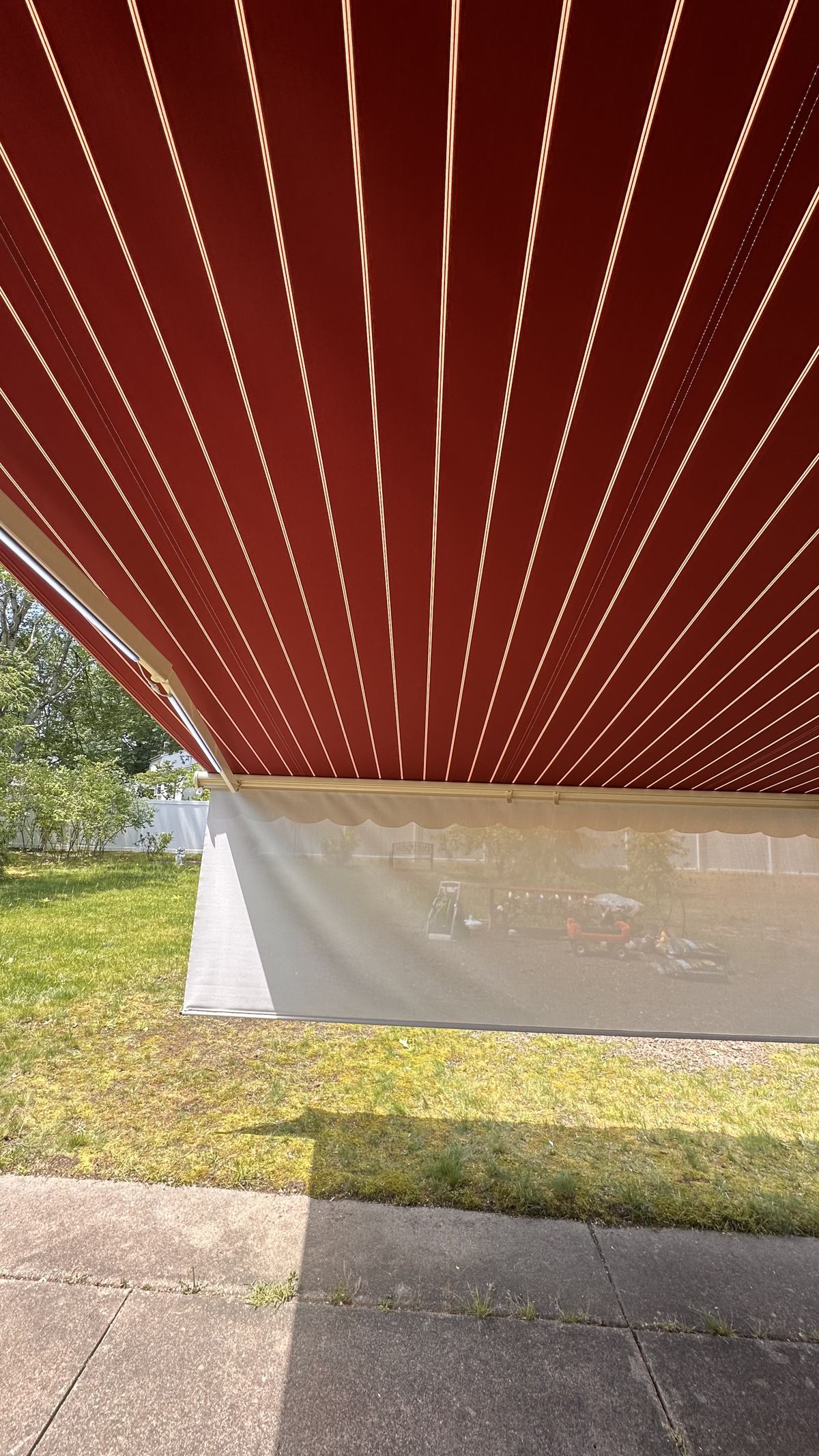 Retractable awning red fabric underneath view