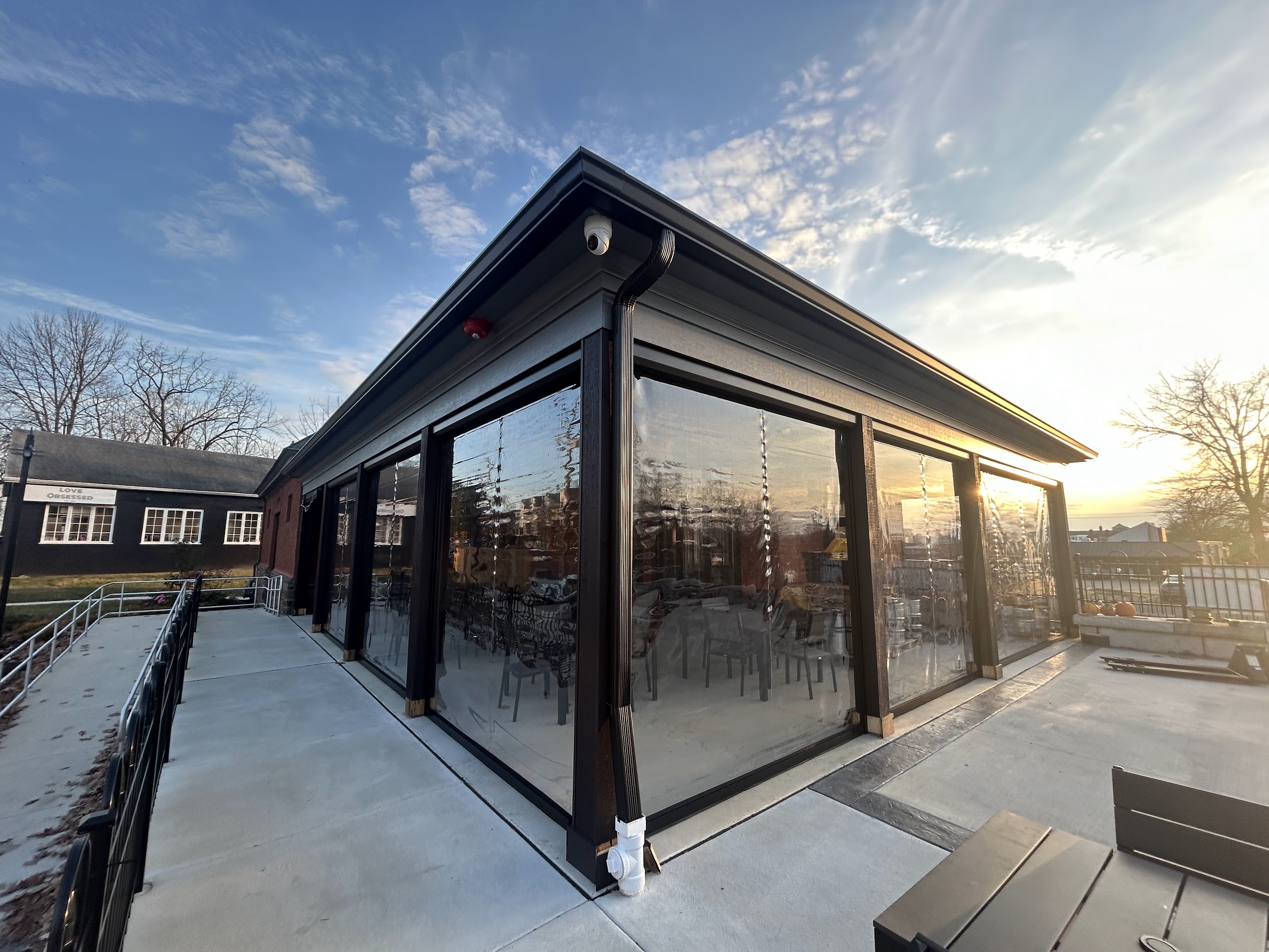 Clear acrylic solar shades enclosing commercial patio
